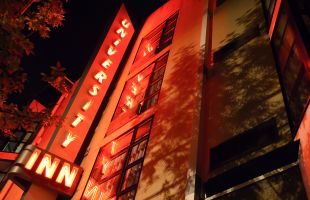 Close up of Exterior hotel sign at night