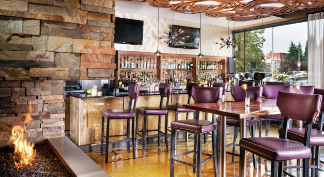 View of bar and seating area in the hotel restaurant and bar Bottle + Kitchen