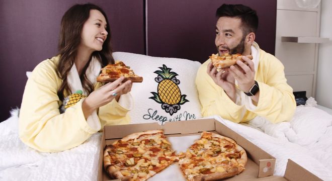 A Woman Eating A Slice Of Pizza