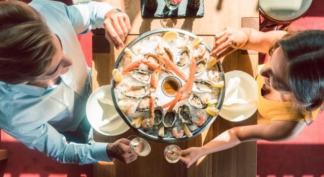 A couple eating crab legs in restaurant