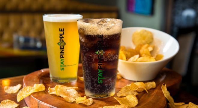 A soft drink, beer and chips on a table