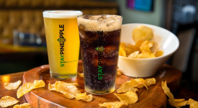 A soft drink, beer and chips on a table