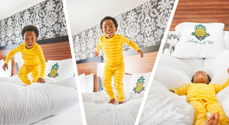 A Small Child jumping On A Bed